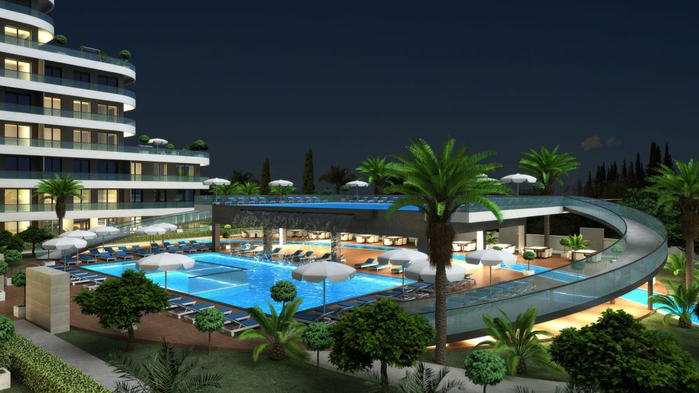 Night view of the modern residential project in Altintas with illuminated pool areaModern Living in Altintas, Antalya – Elegant Apartments and Villas with Social Facilities