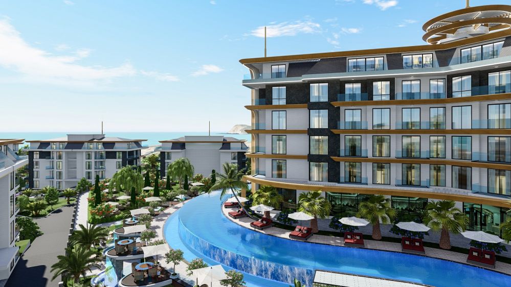 Main building with a large pool surrounded by tropical landscaping.Kestel, Alanya – New Lifestyle: 700 m to the Sea Luxury Residence Project