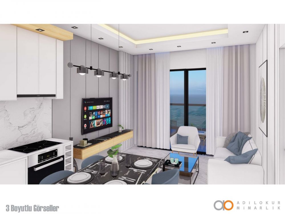 Гостиная с открытой кухней и современным интерьером, создающая уютную атмосферу.Современный жилой комплекс с привлекательными инвестиционными возможностями в Демирташе, Аланья