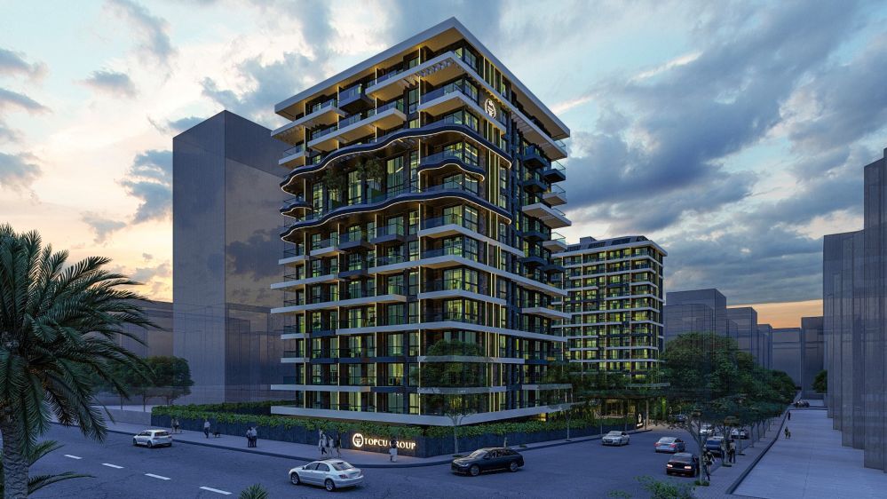 Building illuminated at night with striking modern architecture.Seafront Luxury Apartments in Mahmutlar – New Investment Project in Alanya