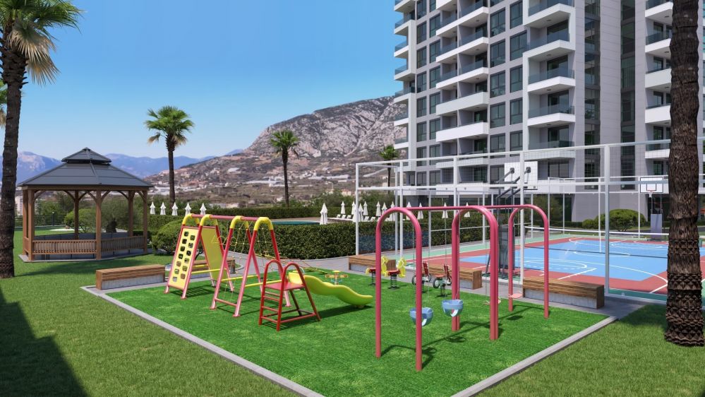 A colorful children’s playground and beautifully designed landscaping provide a safe and pleasant environment for families.Modern Residential Project in Mahmutlar Alanya