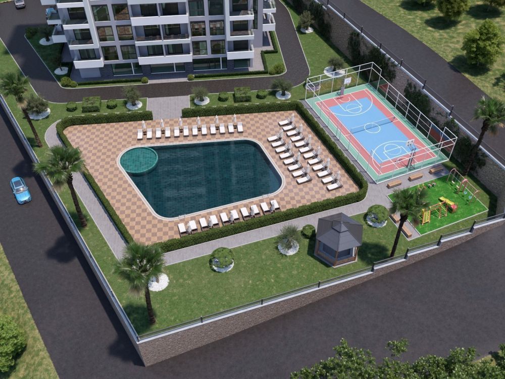 Projenin havuz ve bahçe alanı; spor, dinlenme ve sosyal etkileşim için tasarlanmış, ferah yeşil bir yaşam alanı sunuyor.Alanya Mahmutlar’da Modern Konut Projesi