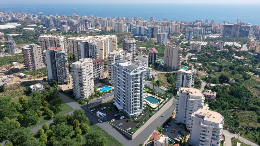 Modern çizgilere sahip 11 katlı rezidans bloğu, Alanya Mahmutlar’da yatırım ve yaşam için ideal bir mimariyle tasarlandı.Alanya Mahmutlar’da Modern Konut Projesi
