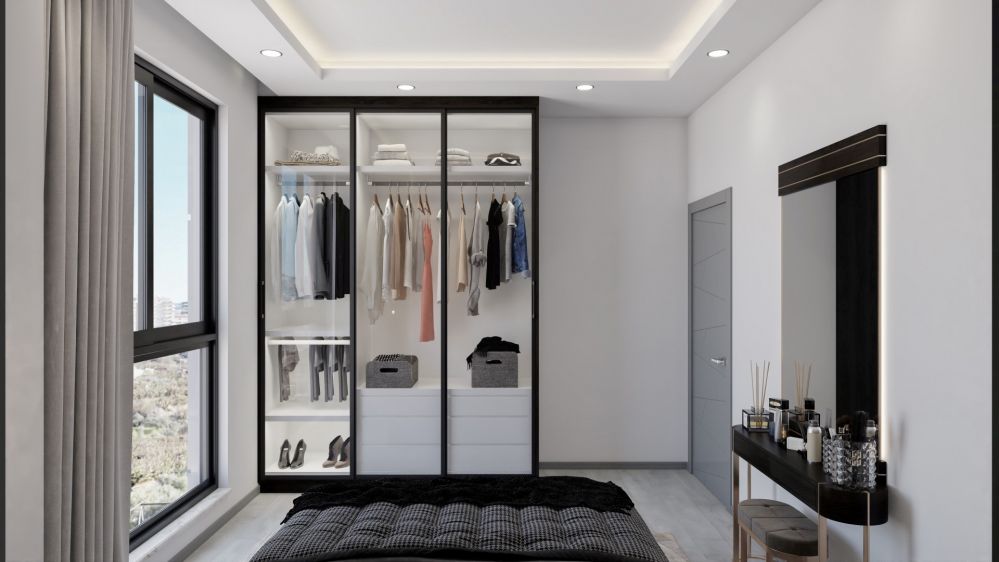 The bedroom combines comfort and functionality with elegant furniture, soft colors, and built-in wardrobe solutions.Modern Residential Project in Mahmutlar Alanya
