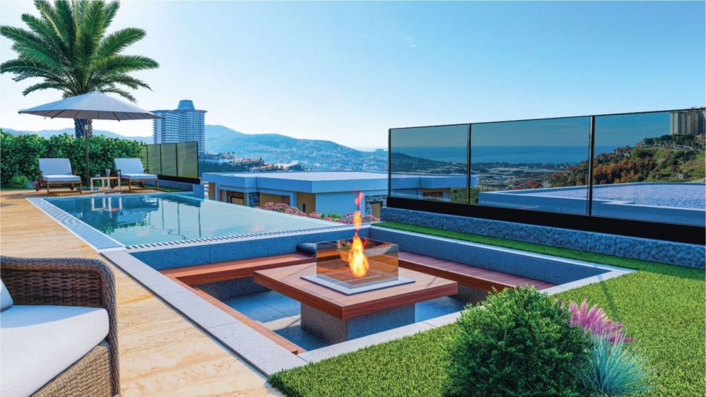 A beautifully landscaped area with scenic seating spaces provides harmony between nature and modern architecture.Ultra Luxury Sea View Residential Project in Kargicak Alanya