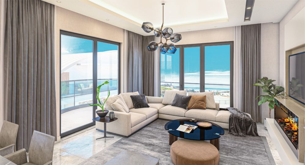 A bright living room with large panoramic windows opening to a sea-view terrace and natural light all day.Ultra Luxury Sea View Residential Project in Kargicak Alanya