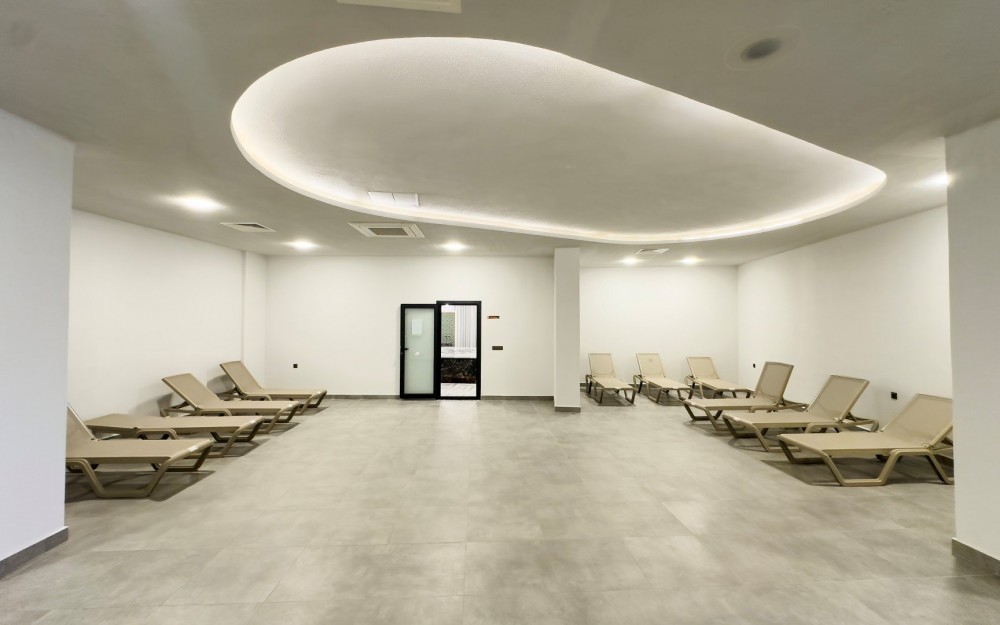 Spa dinlenme salonu, modern ve sade tasarımıyla öne çıkıyor.Akdeniz Kıyısında Lüks ve Konforlu Rezidans Daireler