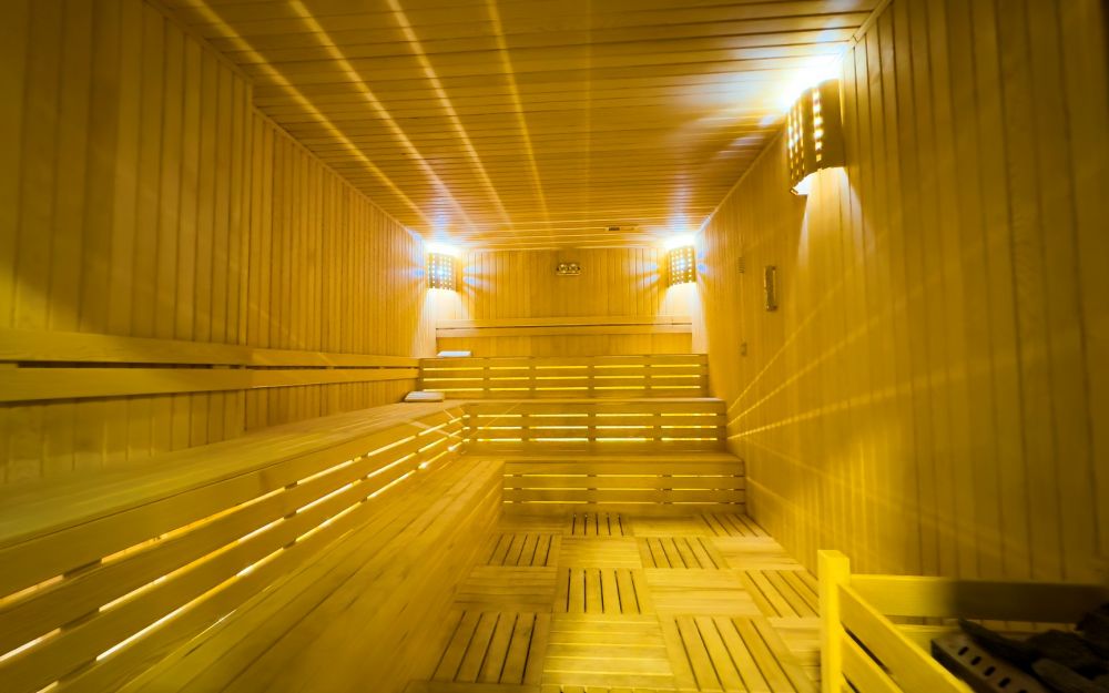 Сауна из натурального дерева с мягким светом и расслабляющей атмосферой. Роскошные и комфортные резиденции на побережье Средиземного моря