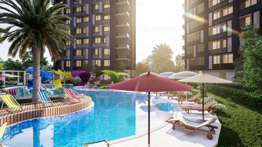 Большой открытый бассейн, зона для загара и ухоженный ландшафт, созданный для комфортной жизни.Современный жилой комплекс в Мерсине Тедже – квартиры 1+1 и 2+1